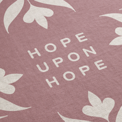 Text 'Hope Upon Hope' on a pink background with floral patterns