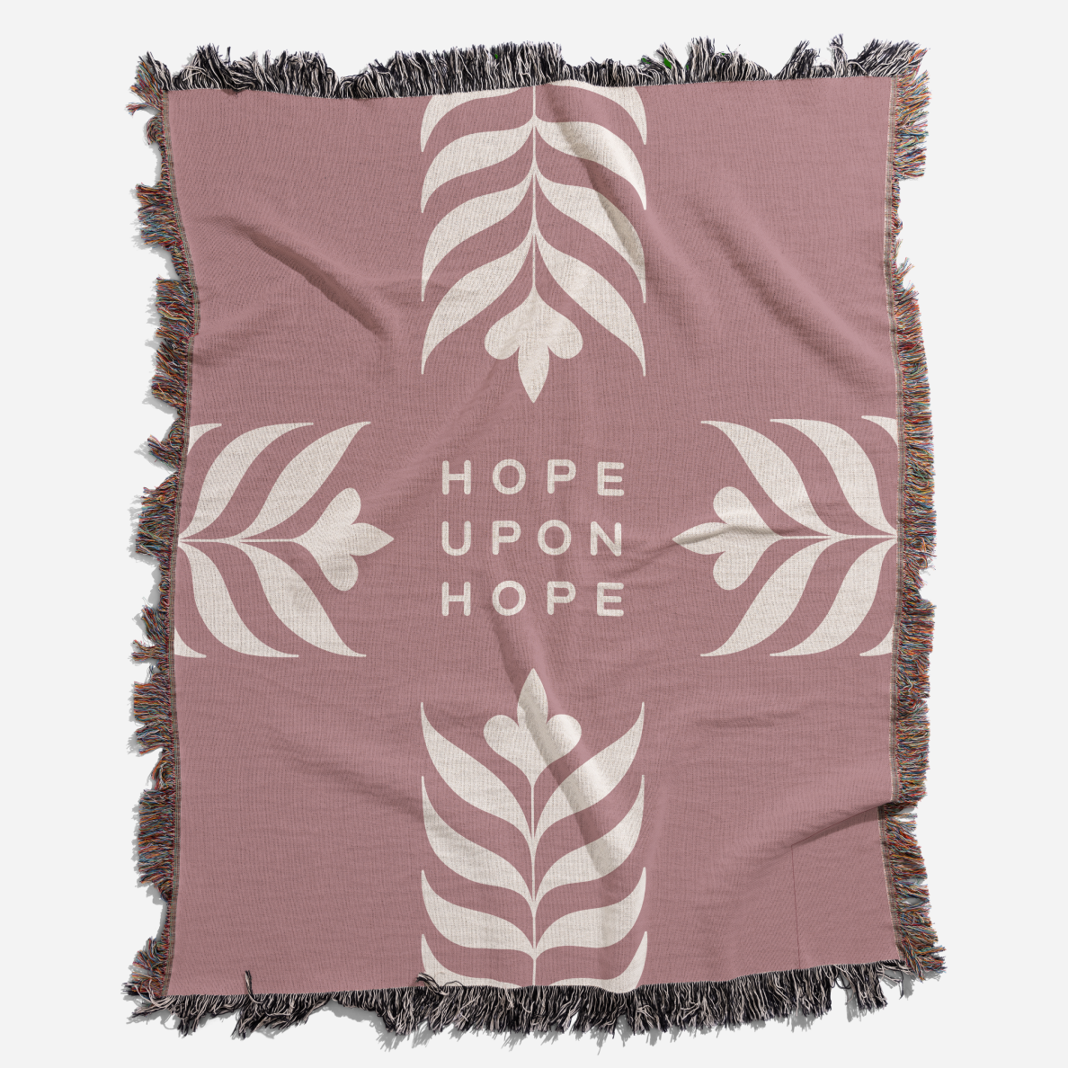 Pink blanket with white leaf patterns and 'Hope Upon Hope' text on a white background