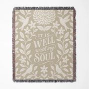 Earthtone green and cream woven blanket with “It is well with my soul,” birds, and floral accents; 100% cotton Christian throw with fringe for peaceful home décor.