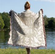 Earthtone green and cream woven blanket with “It is well with my soul,” birds, and floral accents; 100% cotton Christian throw with fringe for peaceful home décor.