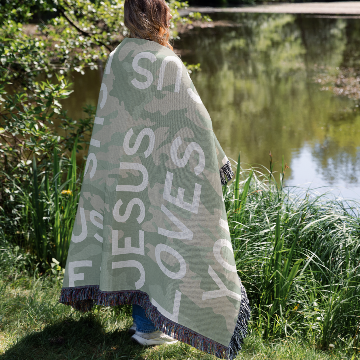 Woman wearing blanket that says Jesus Loves you.