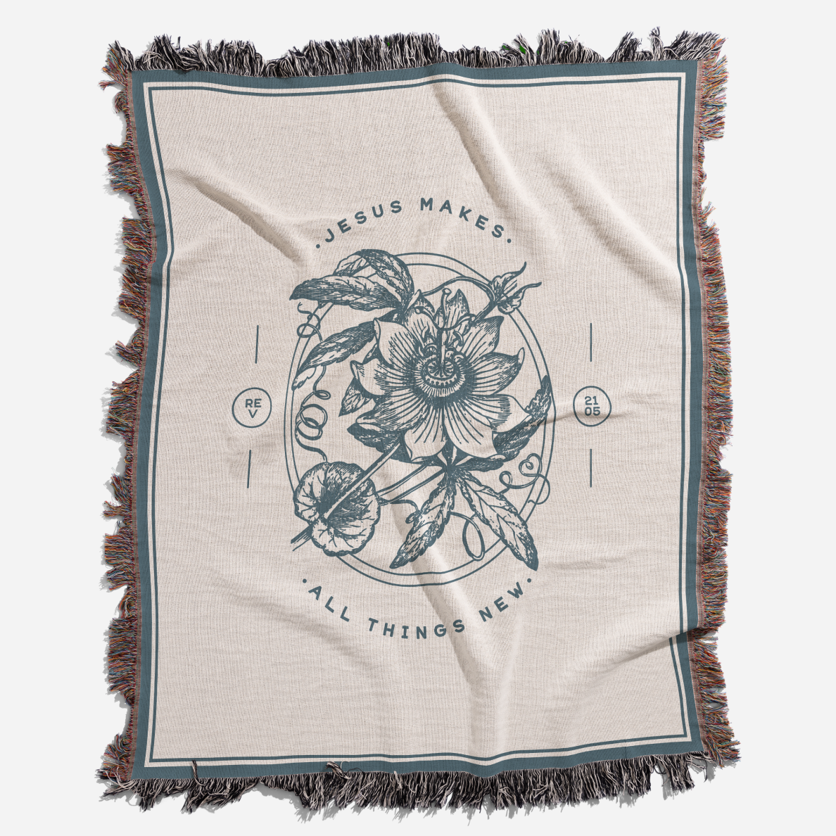 Blanket with floral design and text 'Jesus makes all things new' on a white background