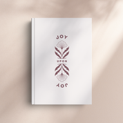 White book with decorative cover design on a beige background