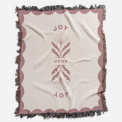Blanket with decorative border and central design on a white background