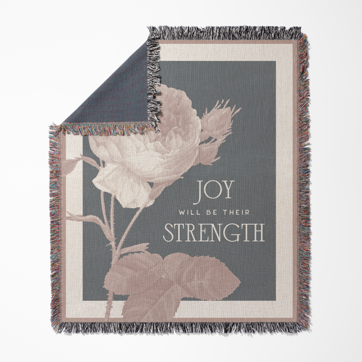 Decorative throw blanket with floral design and text on a white background