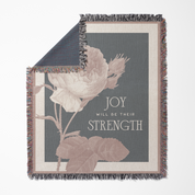 Decorative throw blanket with floral design and text on a white background