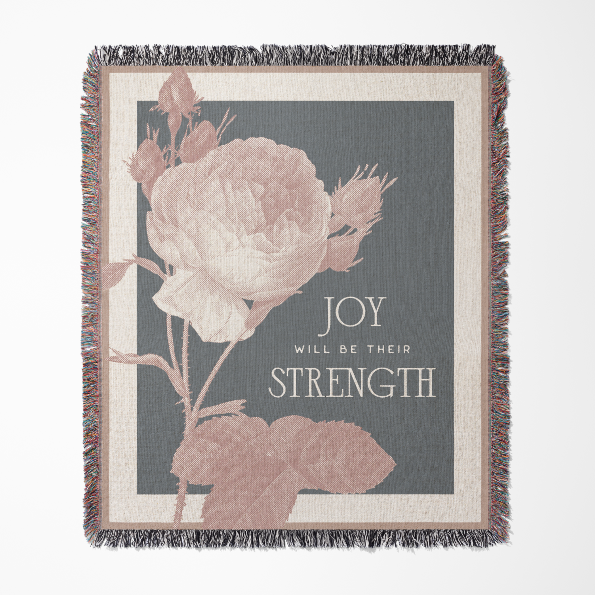 Decorative throw blanket with floral design and motivational quote on a gray background