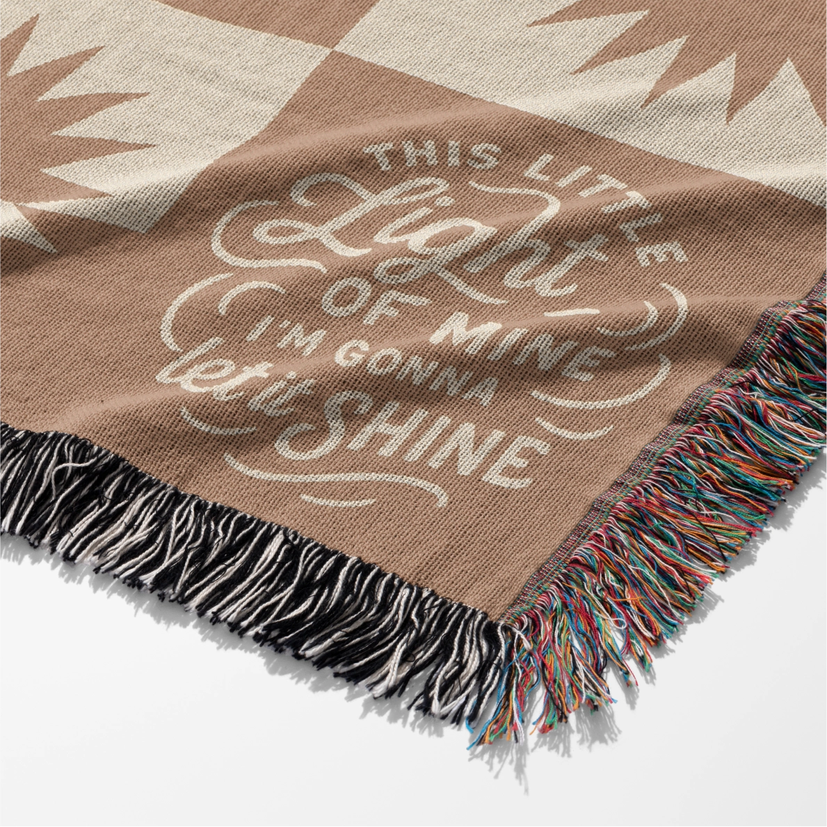 Neutral-toned woven blanket with suns and the phrase “This little light of mine, I’m gonna let it shine,” made from 100% cotton with fringe; perfect for nurseries or Christian baby gifts.