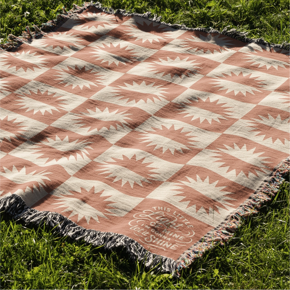 Neutral-toned woven blanket with suns and the phrase “This little light of mine, I’m gonna let it shine,” made from 100% cotton with fringe; perfect for nurseries or Christian baby gifts.