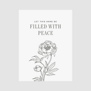 Decorative poster with floral design and text 'Let this home be filled with peace' on a light gray background.