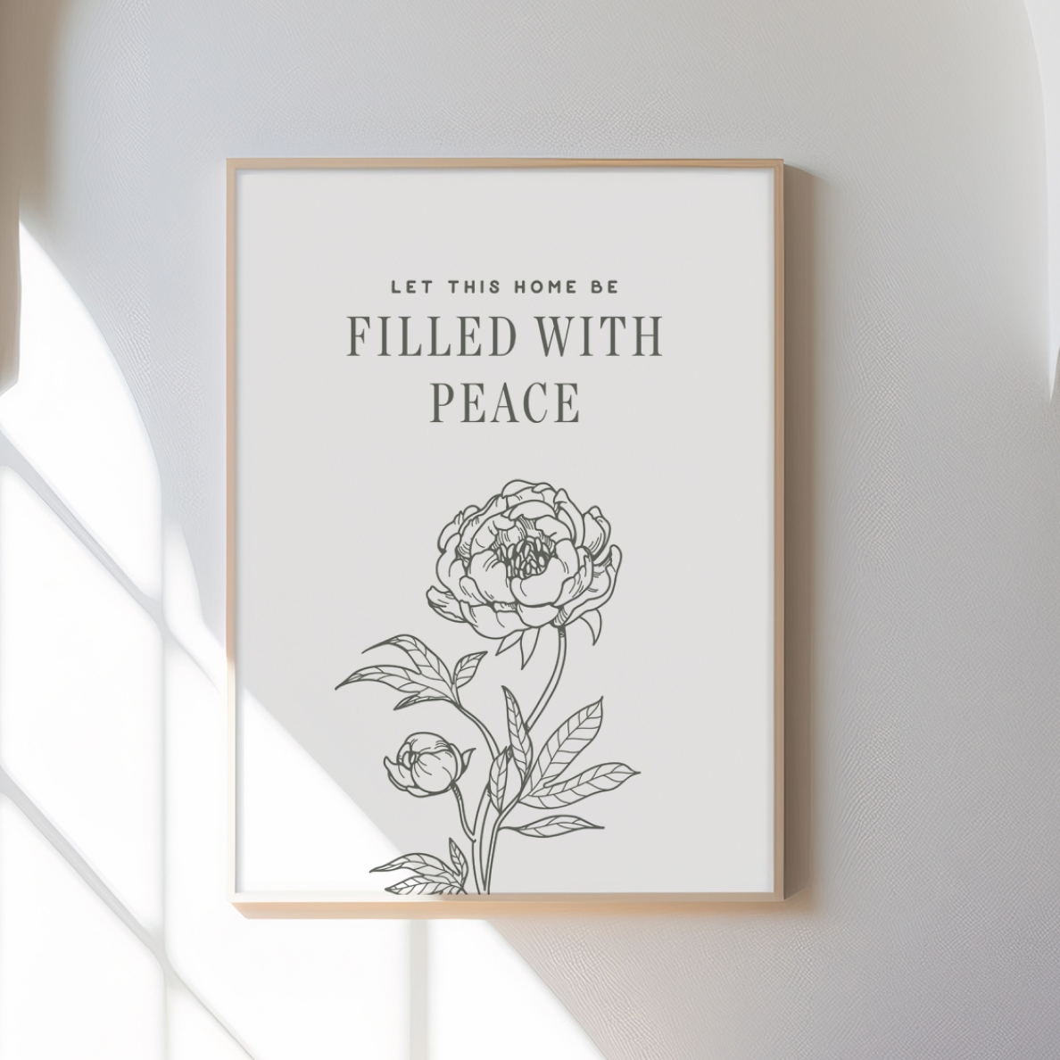 Framed artwork with floral design and text on a white wall