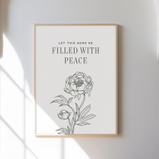 Framed artwork with floral design and text on a white wall