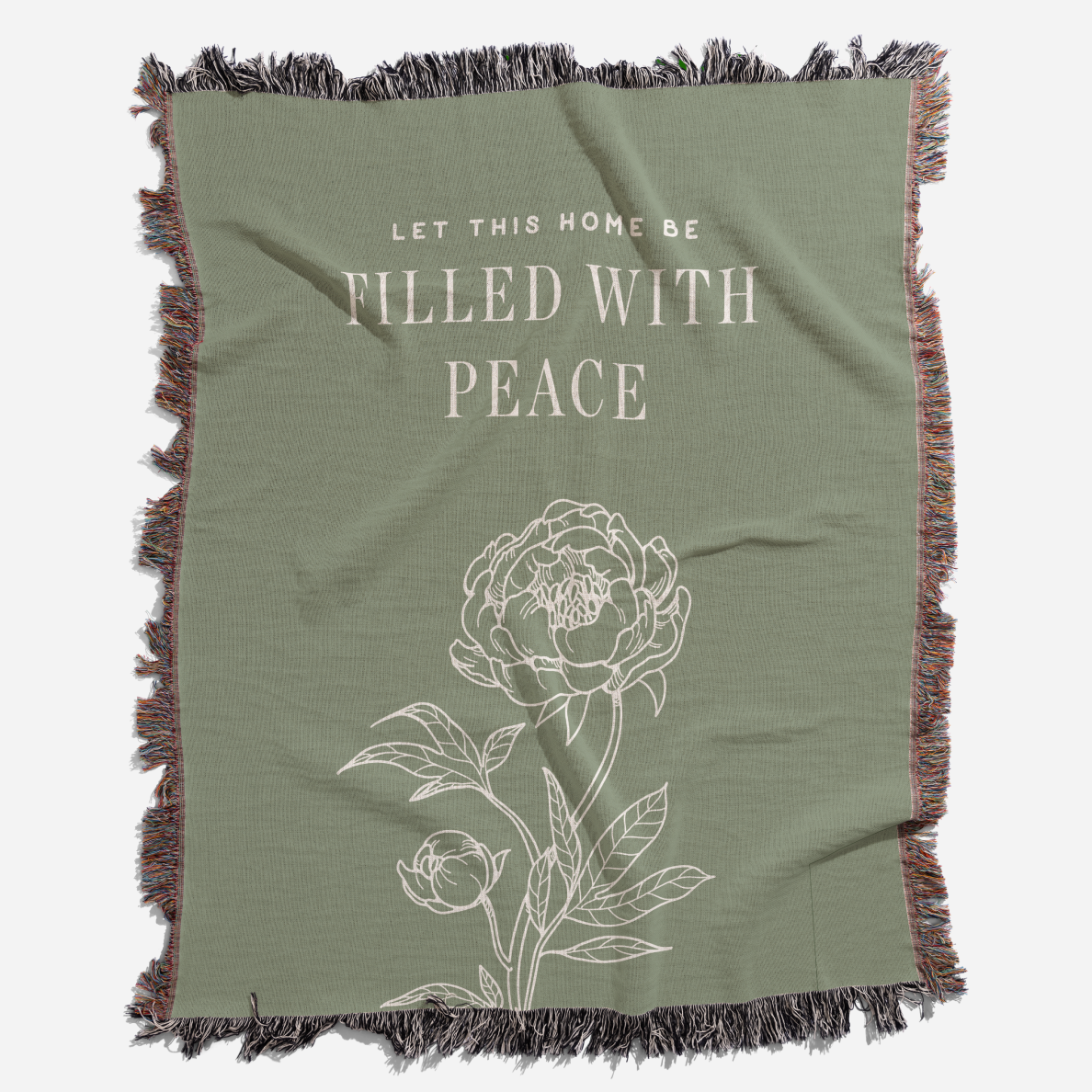 Green throw blanket with floral design and text on a white background