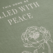 Text 'THIS HOME BE FULLLED WITH PEACE' with a floral design on a green background