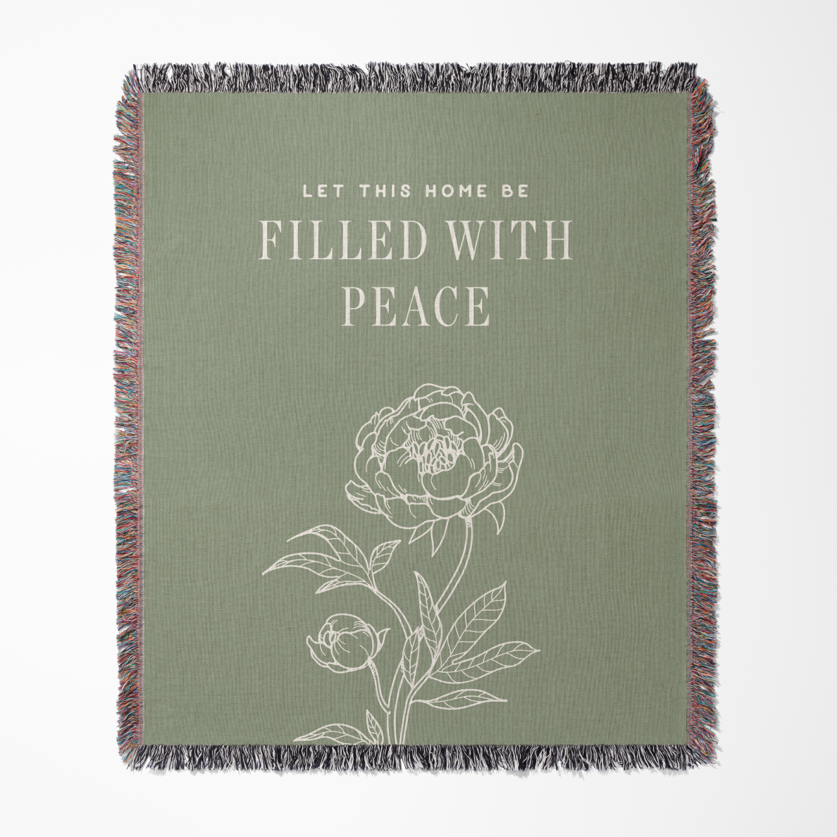 Green throw blanket with floral design and text 'Let this home be filled with peace' on a white background