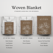 Woven blanket with floral design and text, shown in various sizes on a bed for reference.