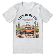 Christian t-shirt with the phrase “Life Is Good – Journey With Him”; soft unisex tee for everyday faith, encouragement, and walking with Jesus.