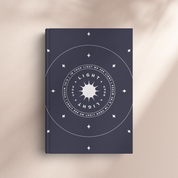 Navy blue book with white circular design and text on a beige background