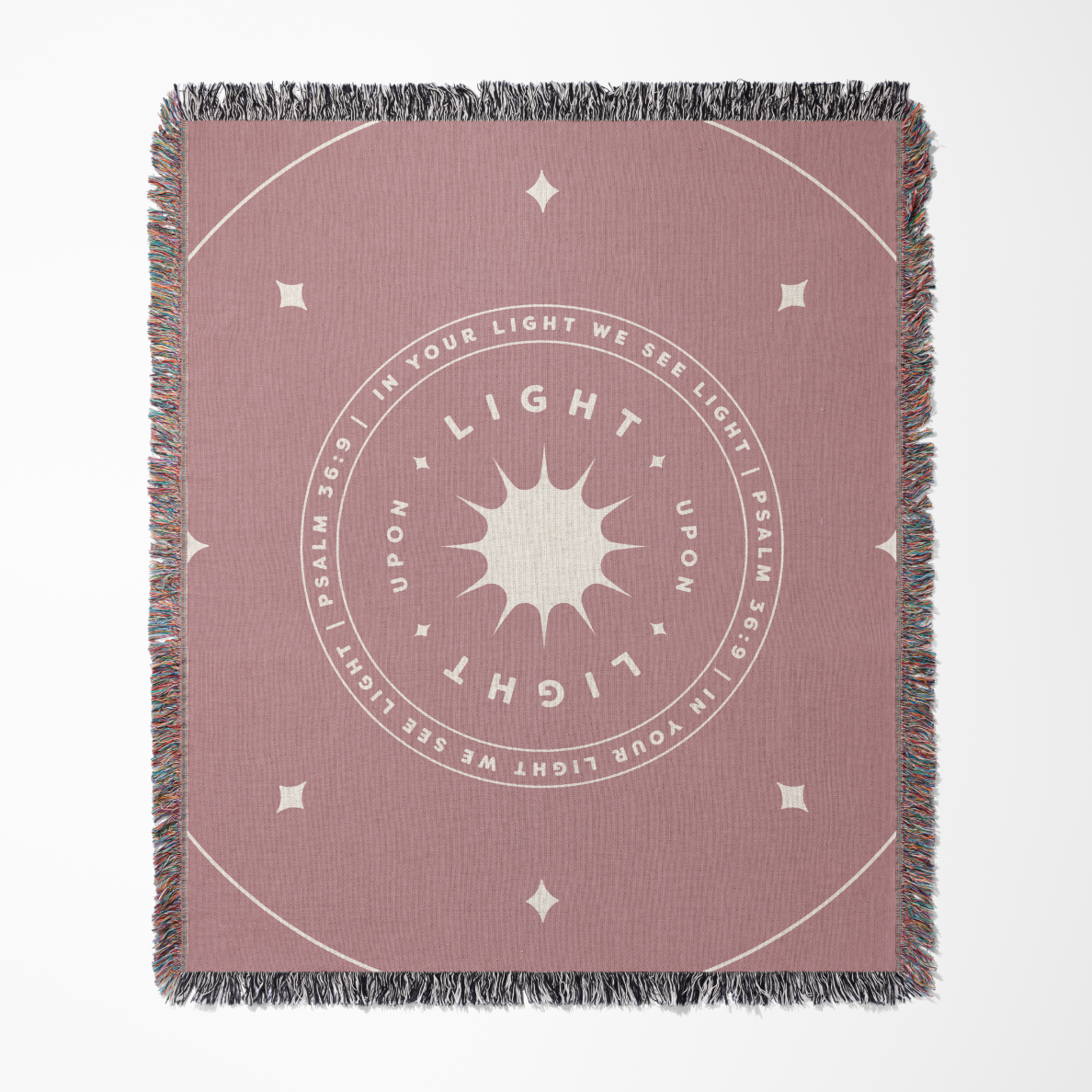 Pink throw blanket with circular design and text on a white background