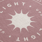 Textured fabric with star design and 'LIGHT UPON' text on a pink background