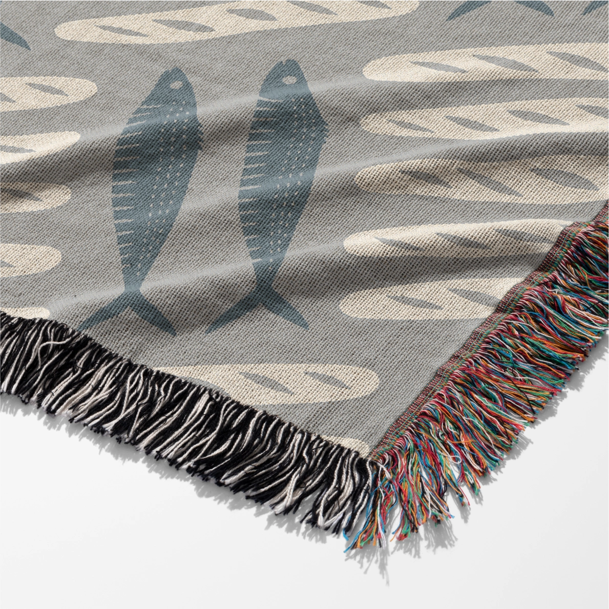 Woven Christian blanket featuring loaves and fishes pattern inspired by the miracle of Matthew 14; 100% cotton with fringe, a symbol of God’s provision and abundance.
