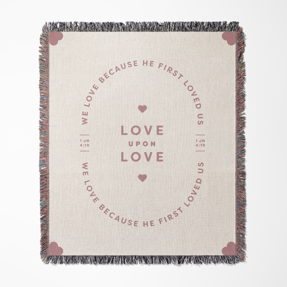 Blanket with text and heart designs on a beige background