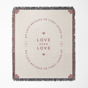 Blanket with text and heart designs on a beige background