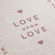 Text 'LOVE UPON LOVE' with heart symbols on a textured beige background