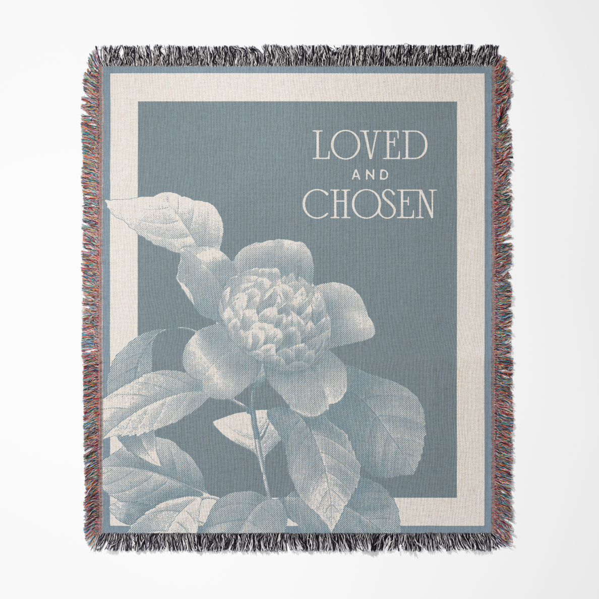 Throw blanket with floral design and 'Loved and Chosen' text on a blue background