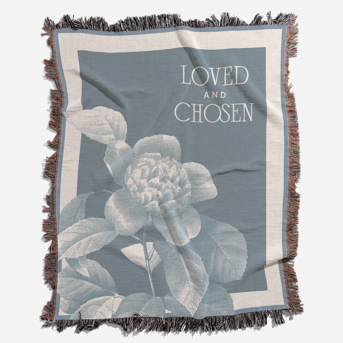 Floral blanket with 'Loved and Chosen' text on a blue background