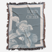Floral blanket with 'Loved and Chosen' text on a blue background