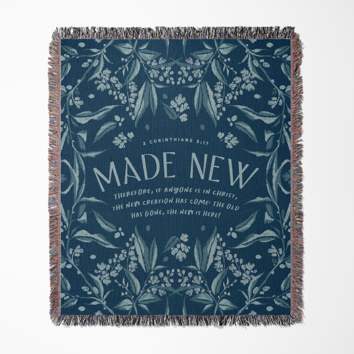 Navy blue woven blanket with floral patterns and 'MADE NEW' text on a white background