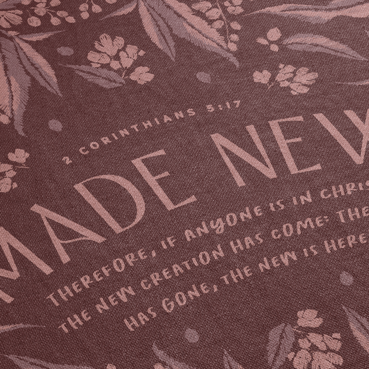 Text with 'Made New' and biblical verse on a floral patterned background