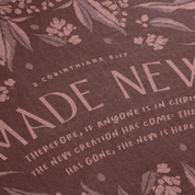 Text with 'Made New' and biblical verse on a floral patterned background