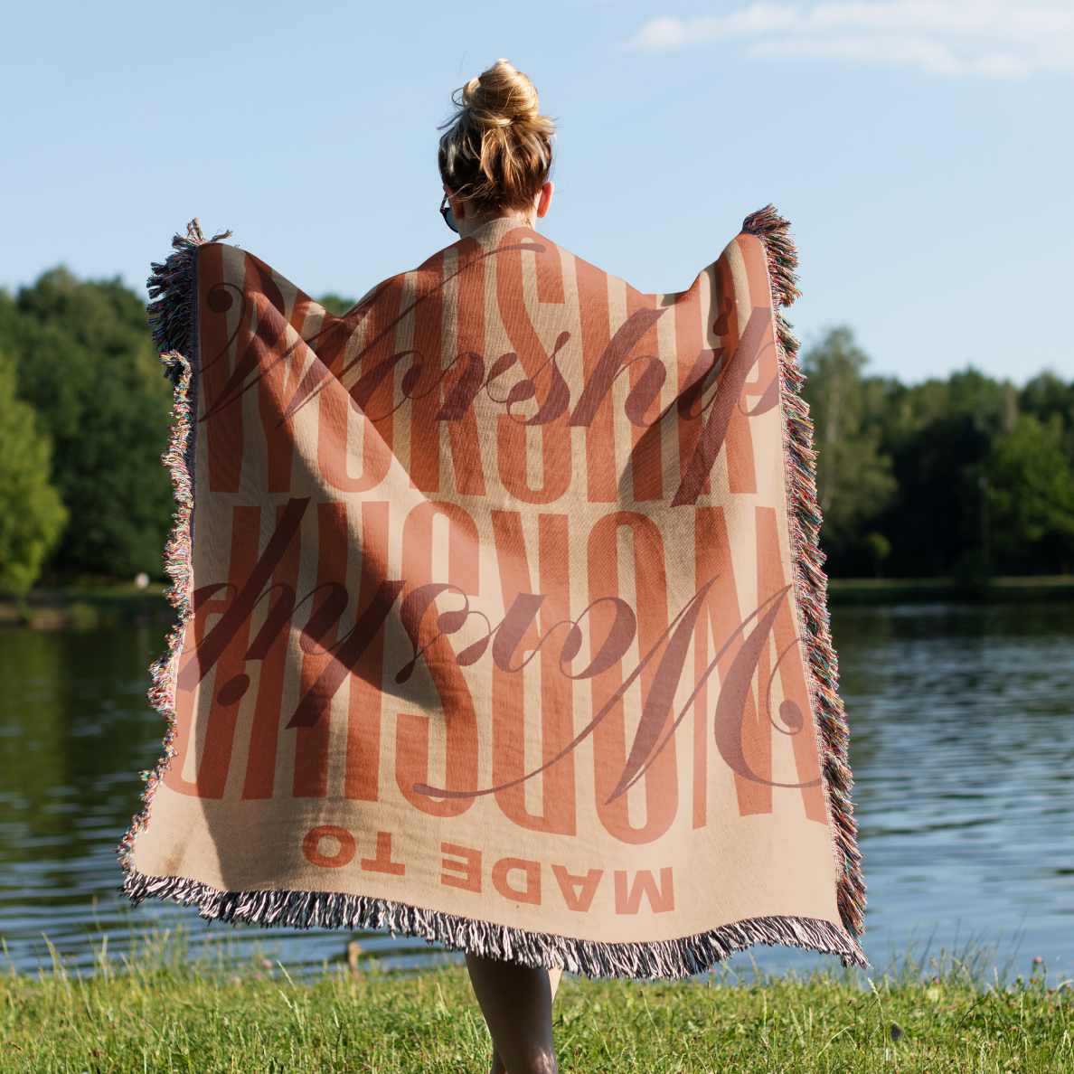 Made to Worship blanket held by woman.