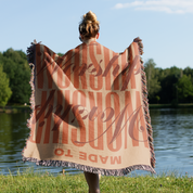 Made to Worship blanket held by woman.