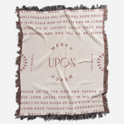 Blanket with religious text and 'Mercy Upon Mercy' design on a white background