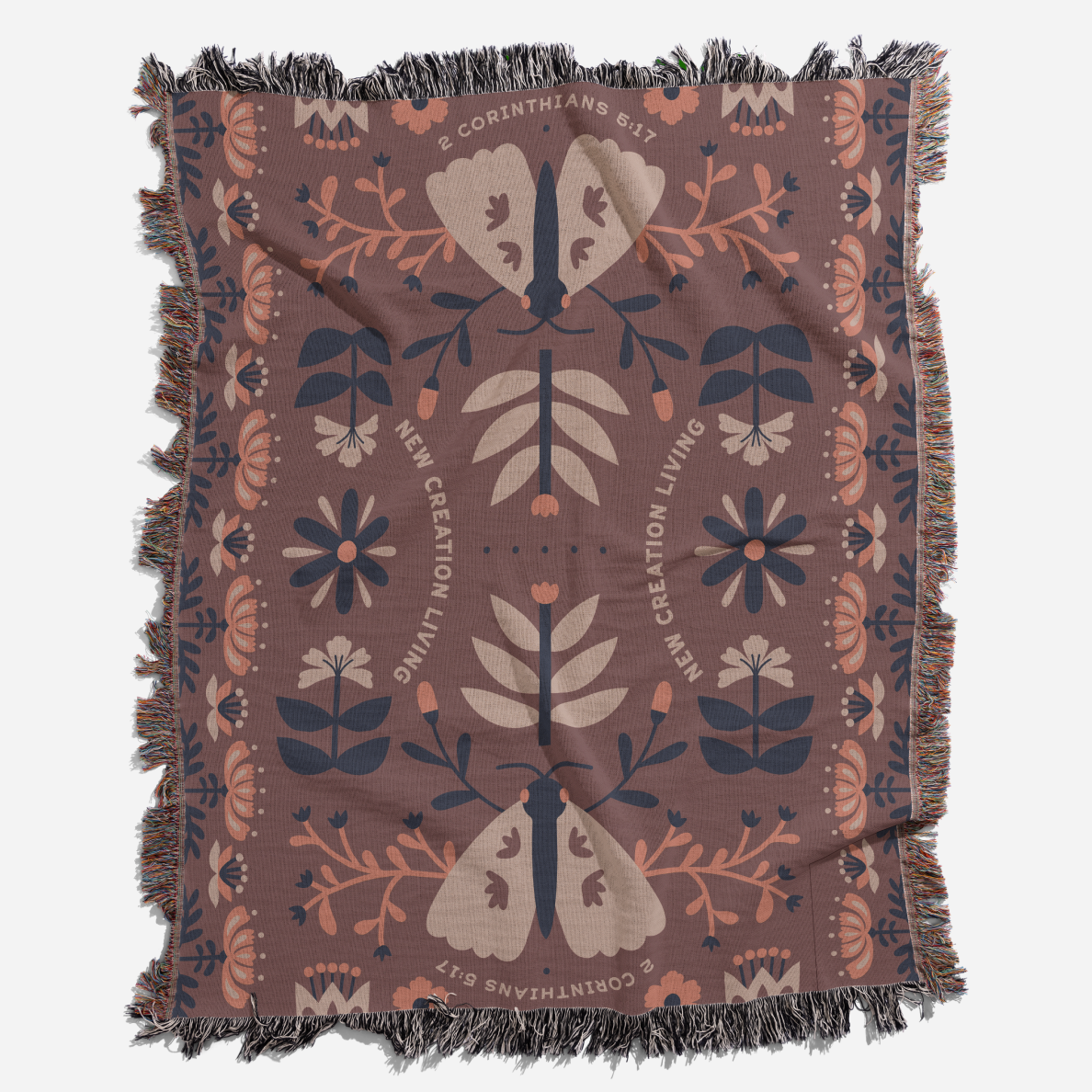 Decorative throw blanket with moth and floral pattern on a brown background