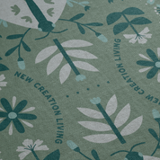 Floral pattern with 'New Creation Living' text on a green background
