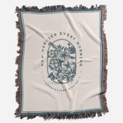 Blanket with floral design and text on a white background