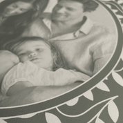 Black and white photo of a family with a decorative border