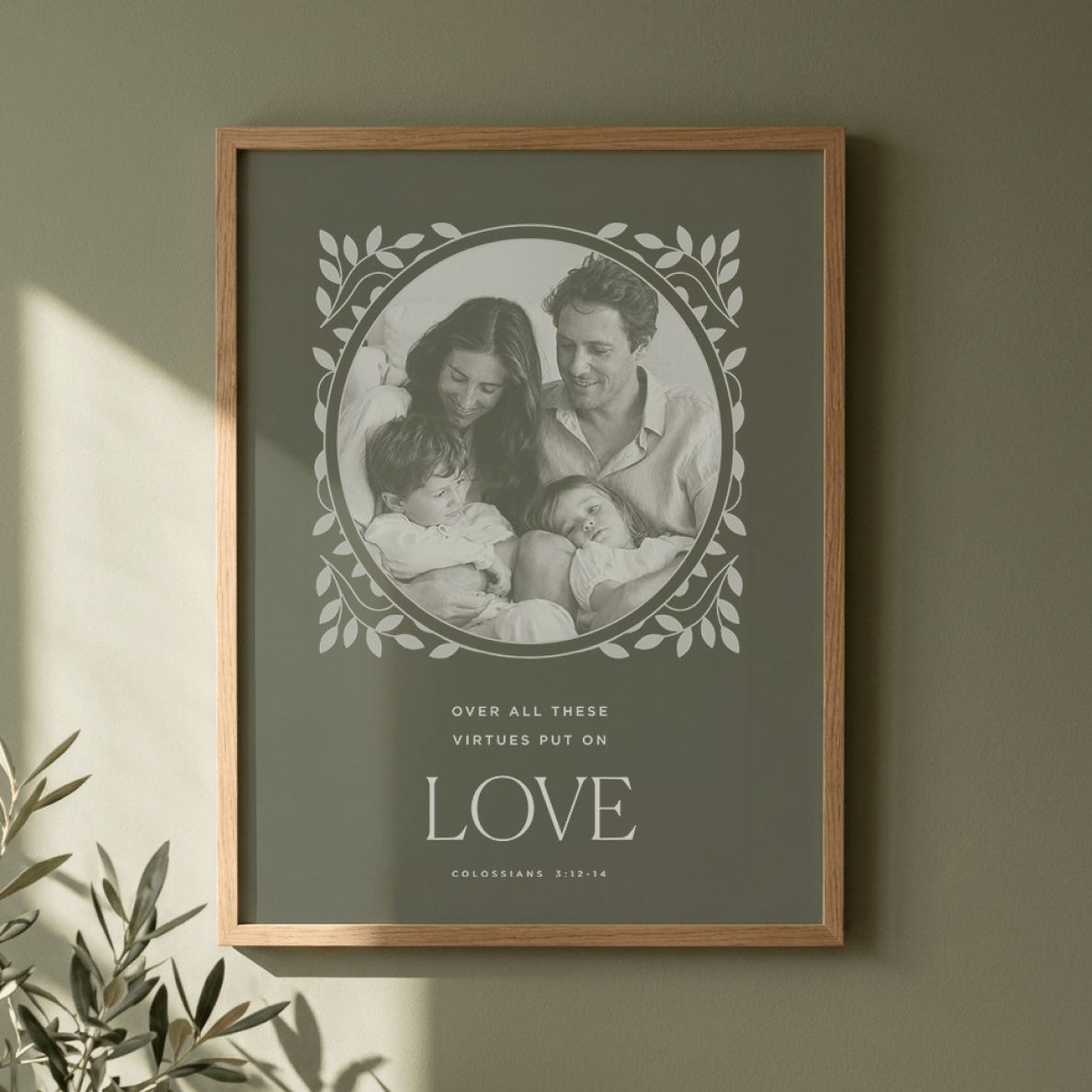 Framed family photo with motivational quote on a green wall