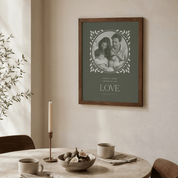 Framed family photo on a wall above a dining table with a candle and bowl.