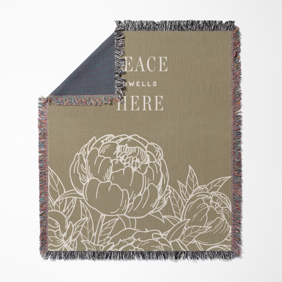Blanket with floral design and 'Peace Wells Here' text on a beige background