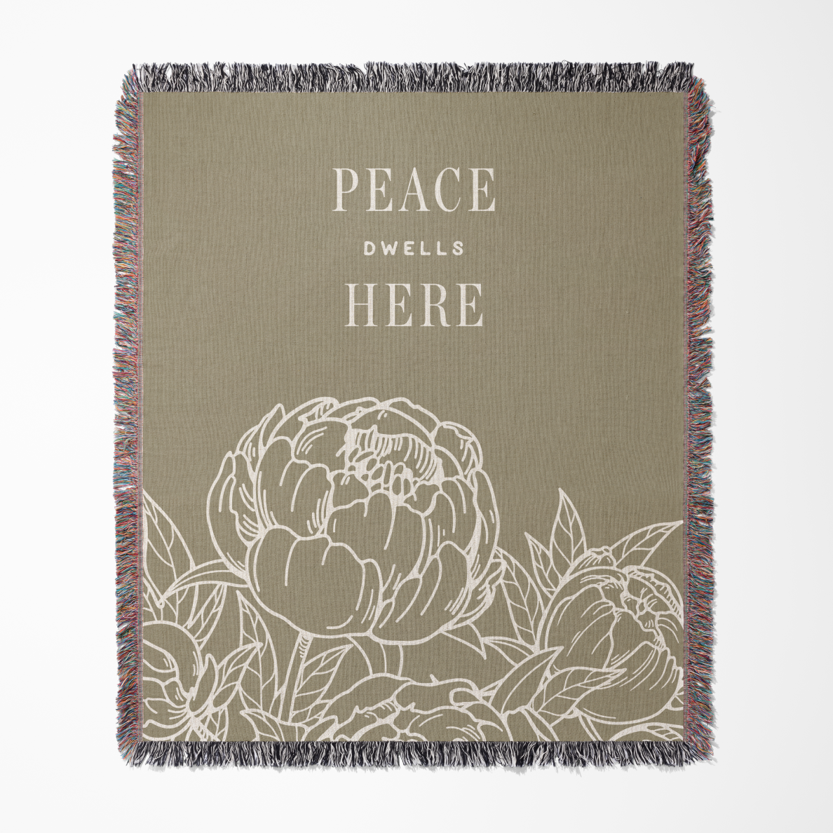 Blanket with floral design and 'Peace Dwell Here' text on a beige background