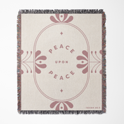 Blanket with 'Peace Upon Peace' text and decorative elements on a beige background