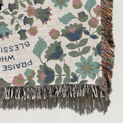 Christian throw blanket with garden-inspired folk art design and the phrase 'Praise God from whom all blessings flow' in soft cottage colors