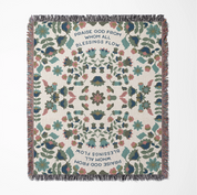 Christian throw blanket with garden-inspired folk art design and the phrase 'Praise God from whom all blessings flow' in soft cottage colors