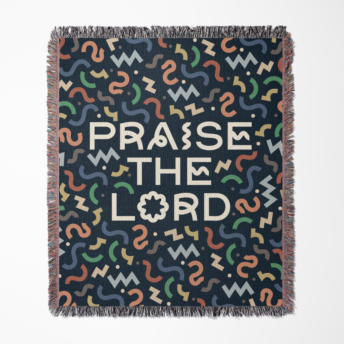 Blanket with colorful pattern and 'Praise the Lord' text on a dark background