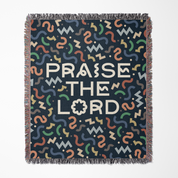 Blanket with colorful pattern and 'Praise the Lord' text on a dark background